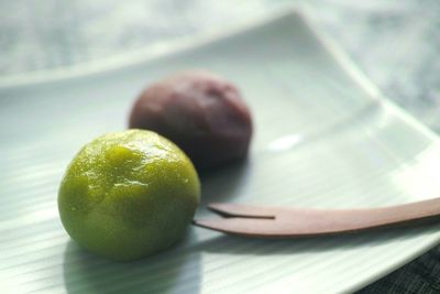 Close-up of desserts by spoon served in plate