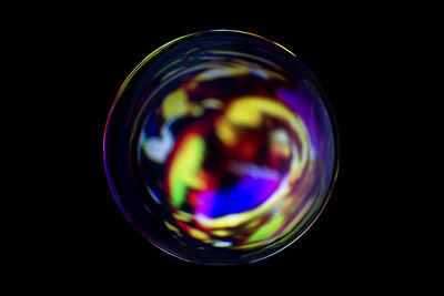 Close-up of bubbles over black background