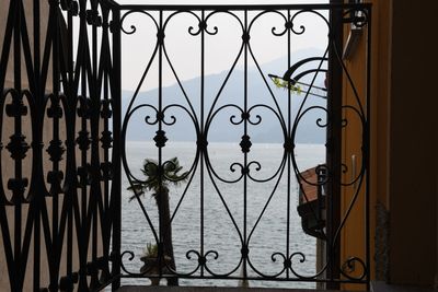 Man seen through metal gate