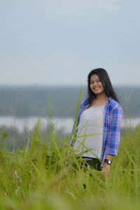 Portrait of smiling young woman on field