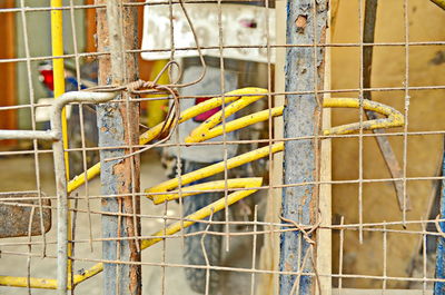Close-up of yellow cage at construction site
