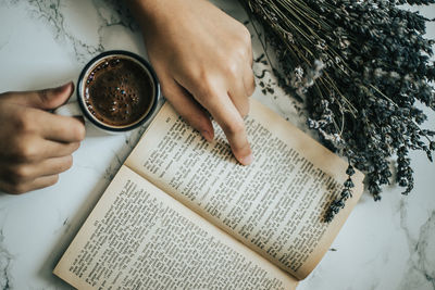 Midsection of woman reading book