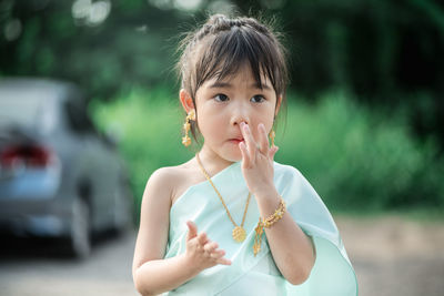 Portrait of cute girl holding camera