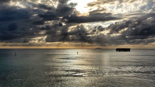 Scenic view of sea against cloudy sky