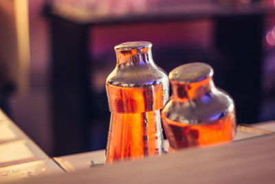 Close-up of glass bottle on table at home