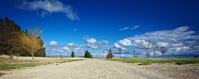 Narrow pathway along countryside landscape