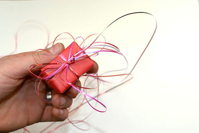 Close-up of person hand holding red tied