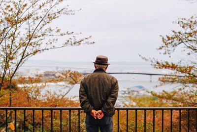 Rear view of man looking at lake