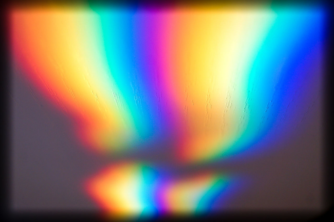 DEFOCUSED IMAGE OF MULTI COLORED LIGHTS