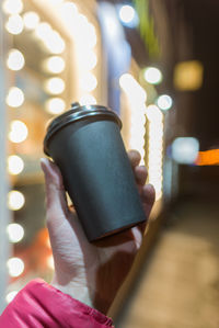 Close-up of hand holding illuminated lighting equipment