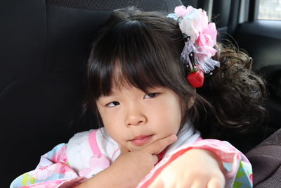 Close-up of cute girl in car