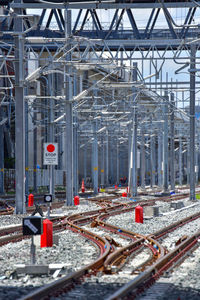 Railroad tracks in city against sky