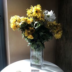 Close-up of yellow flower vase on table