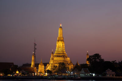 Illuminated temple against clear sky at night