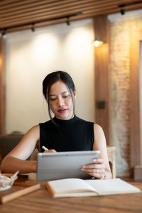 Young woman using laptop at table