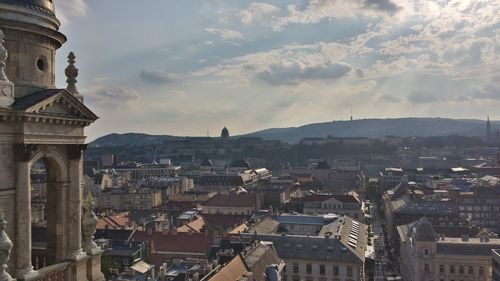 Cityscape against cloudy sky