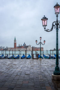 Street light in city against sky