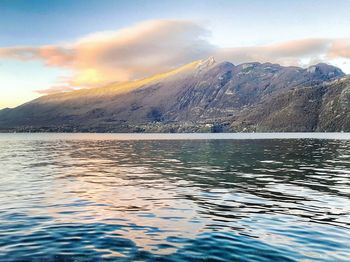 Scenic view of sea and mountains against sky