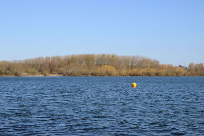 Scenic view of sea against clear blue sky