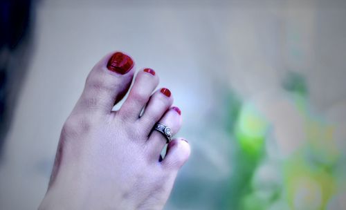 Close-up of woman hand with red eyes