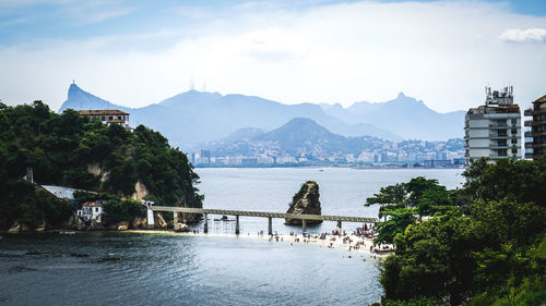 Scenic view of river and mountains against sky