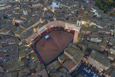 Aerial view of torre del mangia with city skyline at sunset, a famous landmark