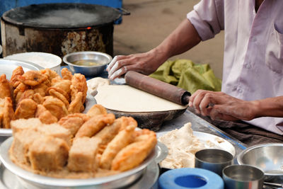 Cropped image of man eating meat