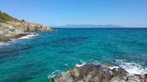 Scenic view of sea against clear blue sky