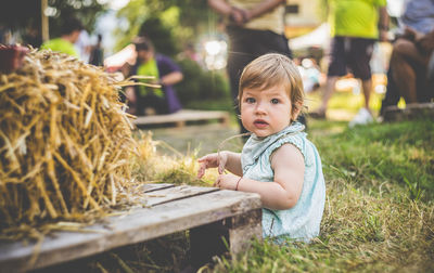 Portrait of a girl sitting on field