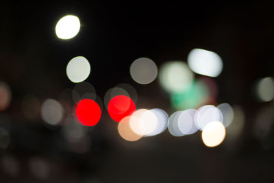 Defocused image of illuminated street lights at night