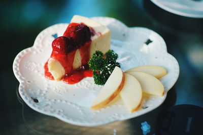 Close-up of cake with apple slice in plate on table