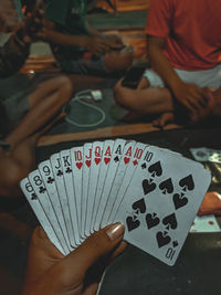 Midsection of people holding hands on table