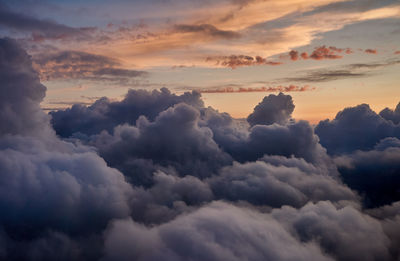 Flying above the clouds during sunset, norway.