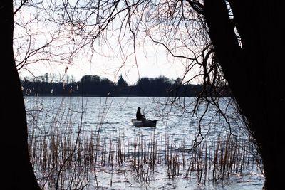 Calm lake with trees in background