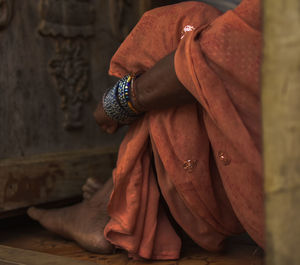 Midsection of woman sitting on floor