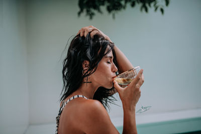 Portrait of woman drinking glass