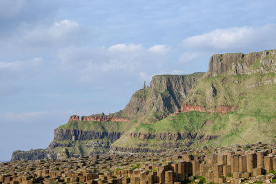 View of giants causeway on mountain against cloudy sky