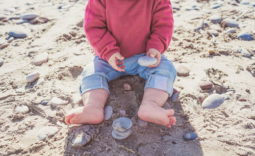 Low section of child on sand