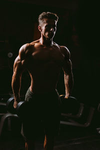 Shirtless man exercising at home