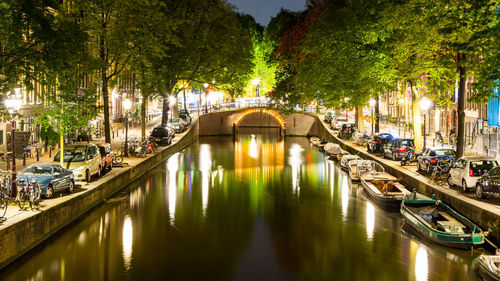 Bridge over canal in city at night