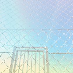 Full frame shot of fence against blue sky