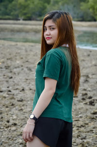 Beautiful young woman lying on beach