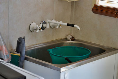 Faucet over bucket in sink