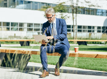 Full length of man using mobile phone