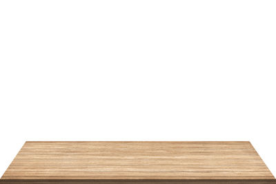 Close-up of wooden table against white background