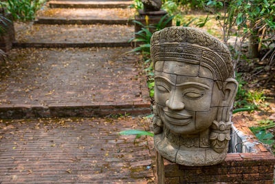 Statue by footpath in park