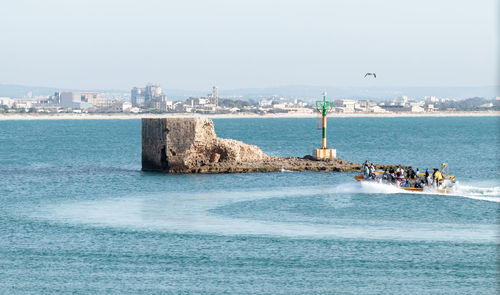 Scenic view of seashore against clear sky