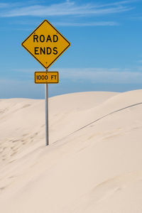 Low angle view of road sign on snow