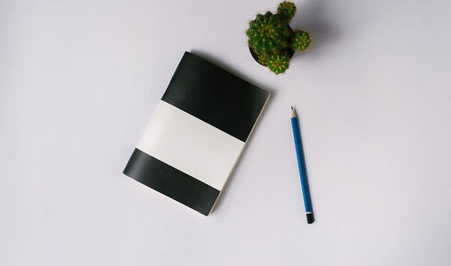 High angle view of black and white pencils on table