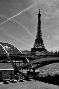 View of bridge and eiffel tower against cloudy sky